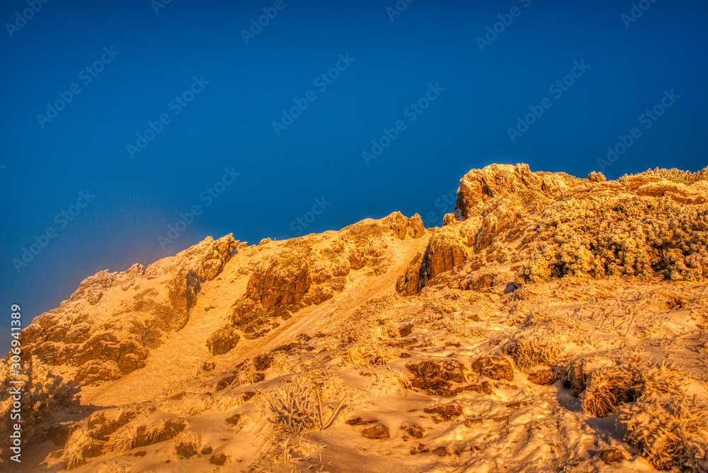 snowy slope of mountain lit by morning at sunrise , Slovakia Litte Fatra , mala fatra ,