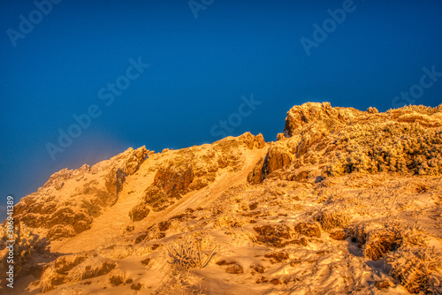 snowy slope of mountain lit by morning at sunrise , Slovakia Litte Fatra , mala fatra ,