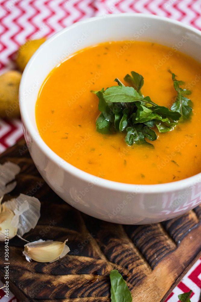 Orange hot pumpkin lentil soup in bowl. Spicy creamy soup with pumpkin puree. Orange hot pumpkin lentil soup in bowl. Spicy creamy soup with pumpkin puree.