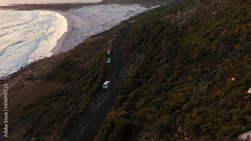 Aerial view of road crossing Scarborough Beach at sunset, South Africa. photo