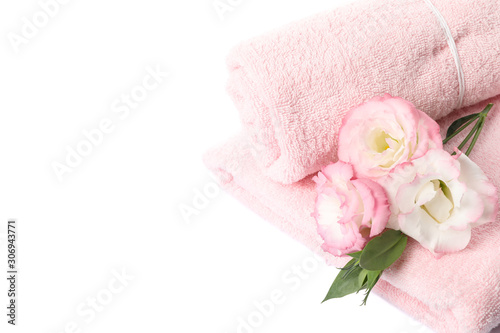 Pink towels and flowers isolated on white background