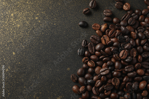Сoffee beans on black background with gold, space for text