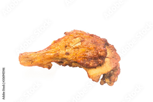 A hong kong-style grilled chicken leg stands alone on a white background