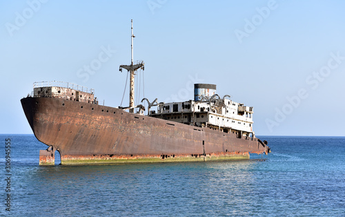 A half-sunken shipwreck Telamon is in the middle of the industrial part of the docks, Lanzarote, Canary Islands, Spain