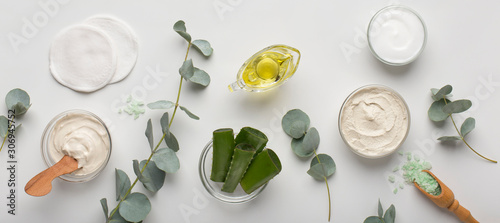 Eco cream products of aloe vera, olive oil and sea salt on white