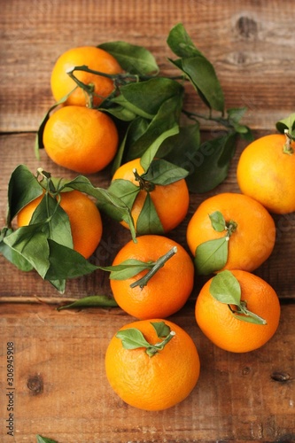 Juicy fresh tangerines with leaves on the table 