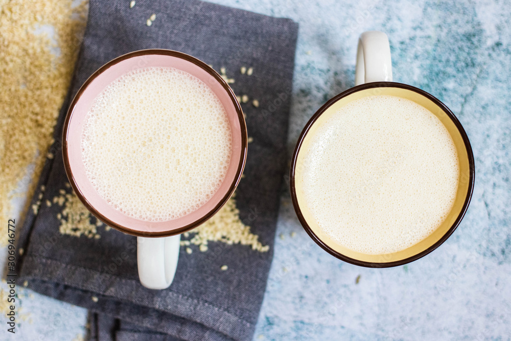 Plant milk. Plant based non-diary milk healthy vegan drink with sesame seeds in cup or mug. No milk diary Plant milk. Plant based non-diary milk healthy vegan drink with sesame seeds in cup or mug. No milk diary