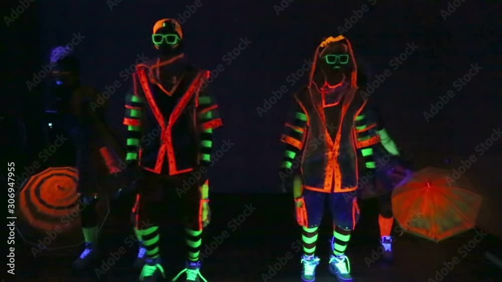 Dance group in neon costumes Dance group in neon costumes