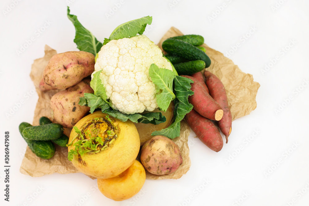 Cauliflower, sweet potato, turnip on Kraft paper on white background. Organic agricultural vegetables, healthy food concept, plant background, natural eco-products, organic food Cauliflower, sweet potato, turnip on Kraft paper on white background. Organic agricultural vegetables, healthy food concept, plant background, natural eco-products, organic food