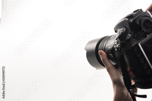 cropped view of photographer working with digital camera isolated on white photo