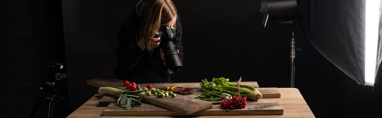 professional photographer making food composition for commercial photography and taking photo on digital camera , panoramic shot