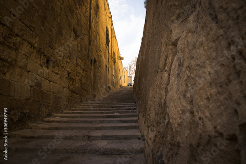 typical narrow street with stairs in the city Valetta