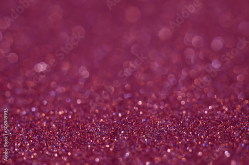 Abstract festive pink bokeh background with shining defocus sparkles. Blurred glitters shimmering dust macro close up, copy space for text logo