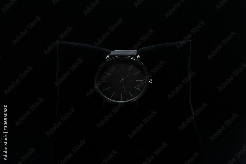 Wrist watch on a black background. Watch in a case on a black velvet pillow Wrist watch on a black background. Watch in a case on a black velvet pillow