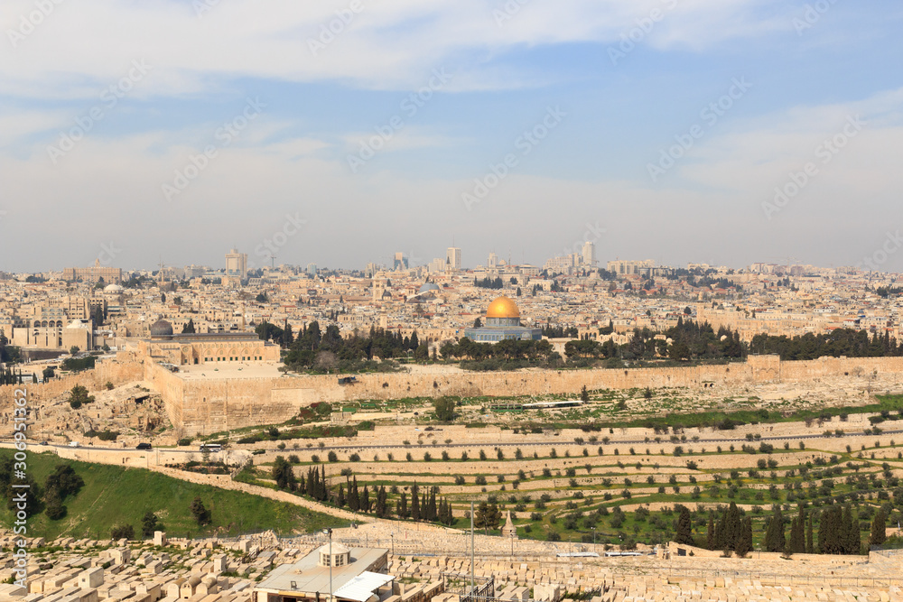 Mount of Olives Jewish Cemetery and Jerusalem Old city cityscape panorama with Dome of the Rock with gold leaf and Al-Aqsa Mosque on Temple Mount and Rotunda of Church of the Holy Sepulchre, Israel