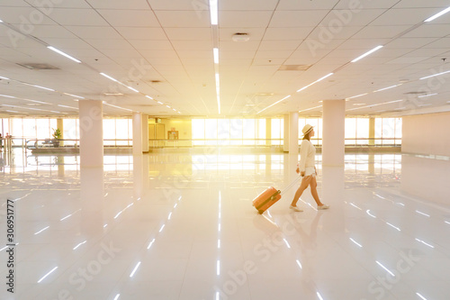 she is traveling on a plane, dragging luggage through the aisles for traveling. photo