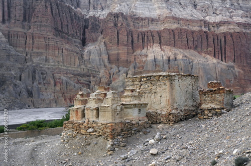 Buddhist chortens and ruins among the shale mountains in the vicinity of Chusang. Trekking to the Upper Mustang, Nepal. photo