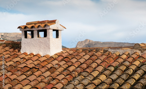 Typical Spanish roof covered in S style terracotta clay roof tiles photo