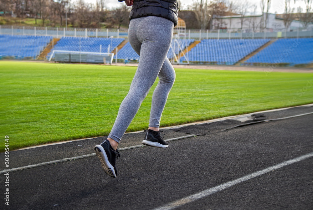 Fototapeta premium Girl is engaged in jogging
