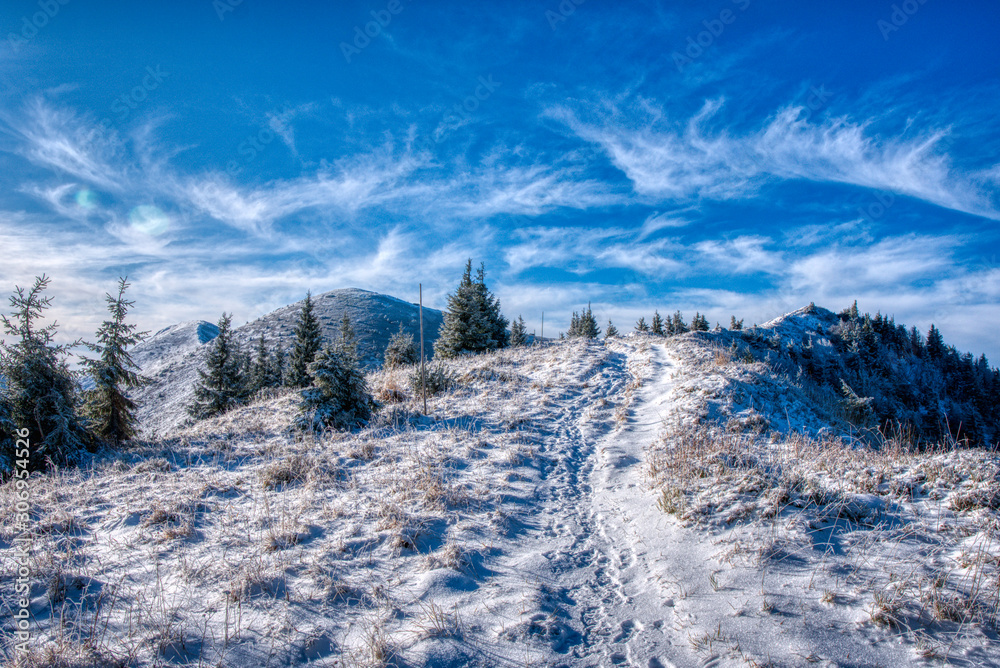 beautiful trail on the ridge in the mountains covered with snow