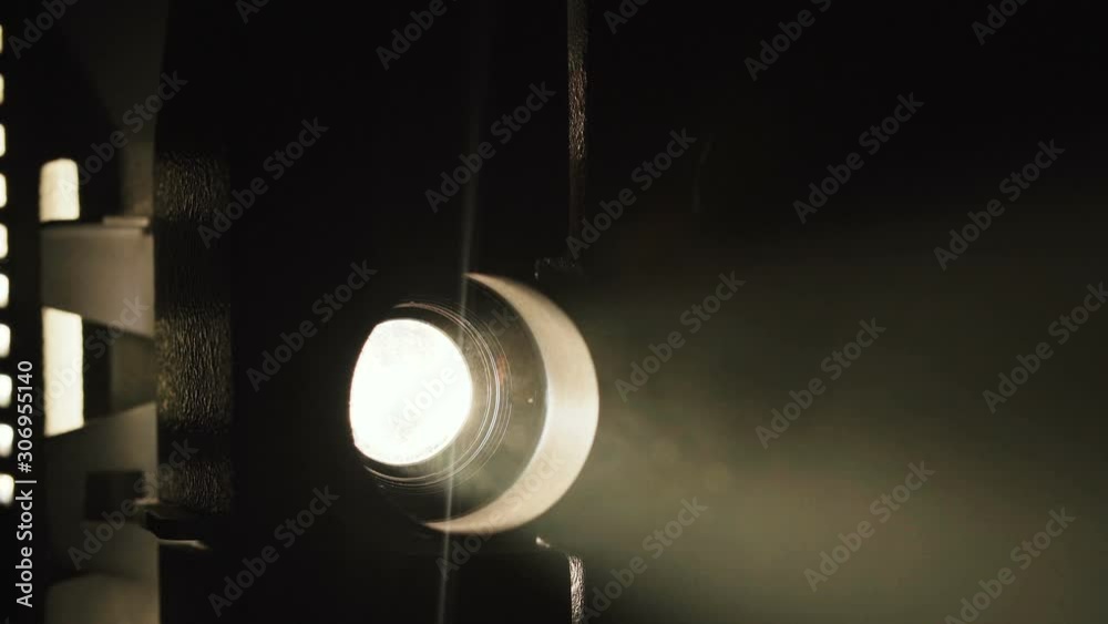 Footage of old film projector on black background