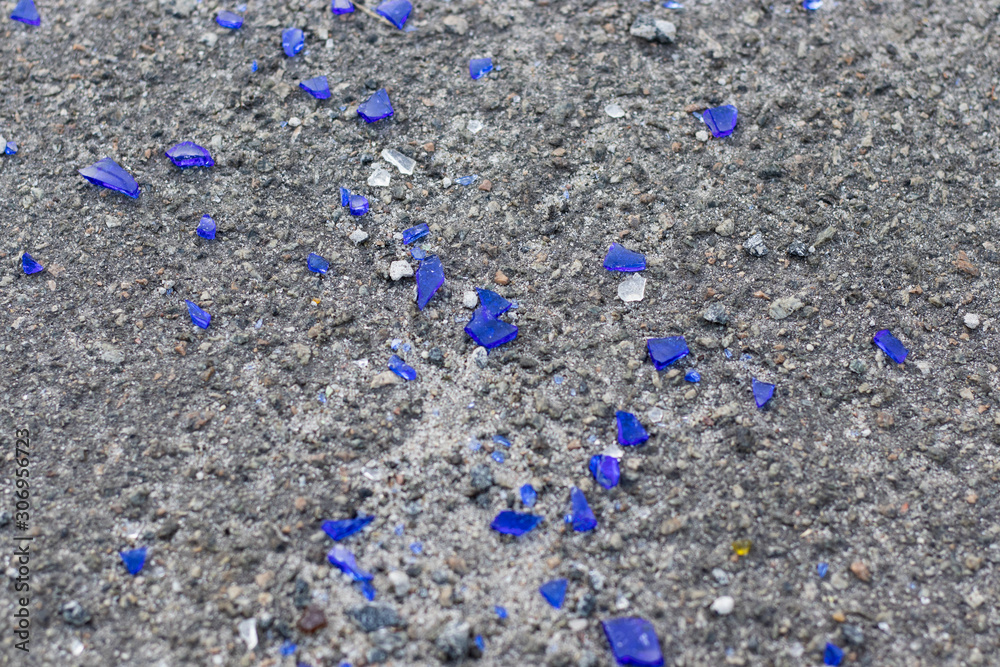 Blue broken glass on the asphalt Blue broken glass on the asphalt