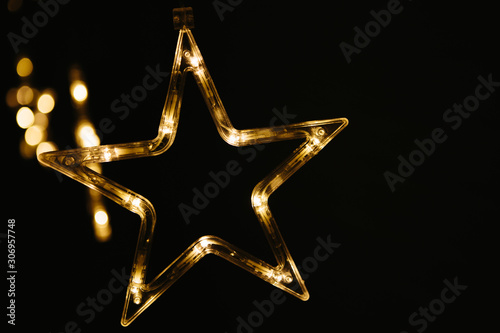 Christmas lights on dark background. Star shaped.
