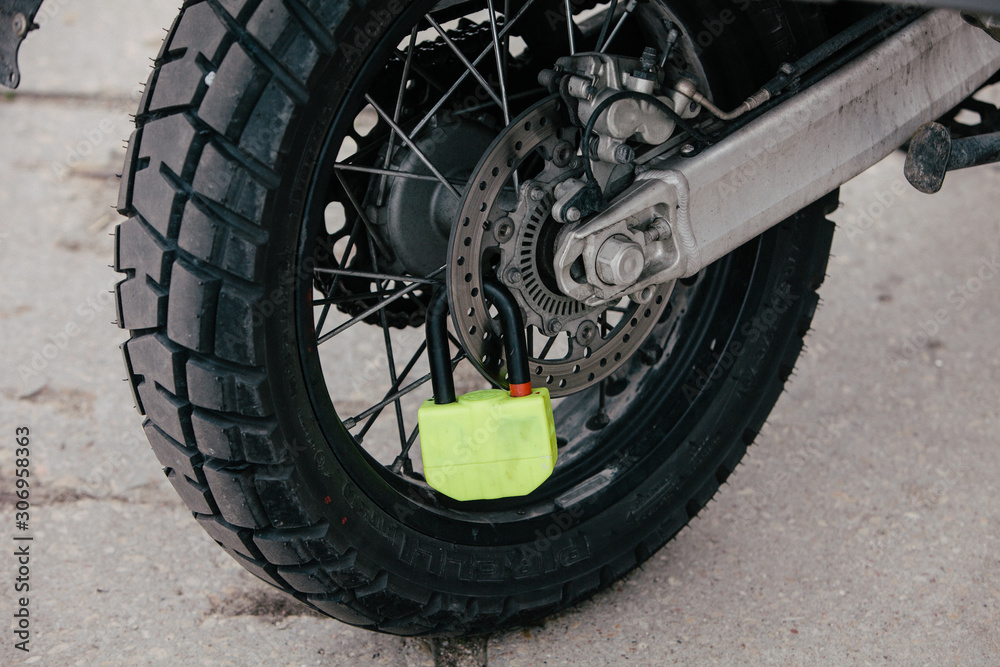 Bike chain and wheel lock on the street Bike chain and wheel lock on the street