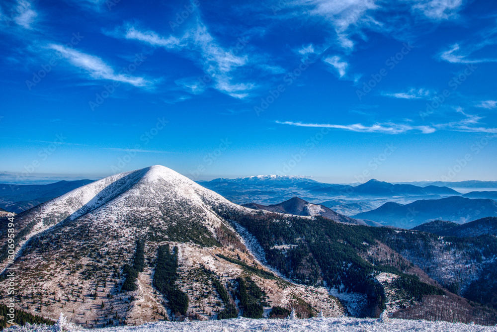Mountain under snow cover with High Tatras in the background