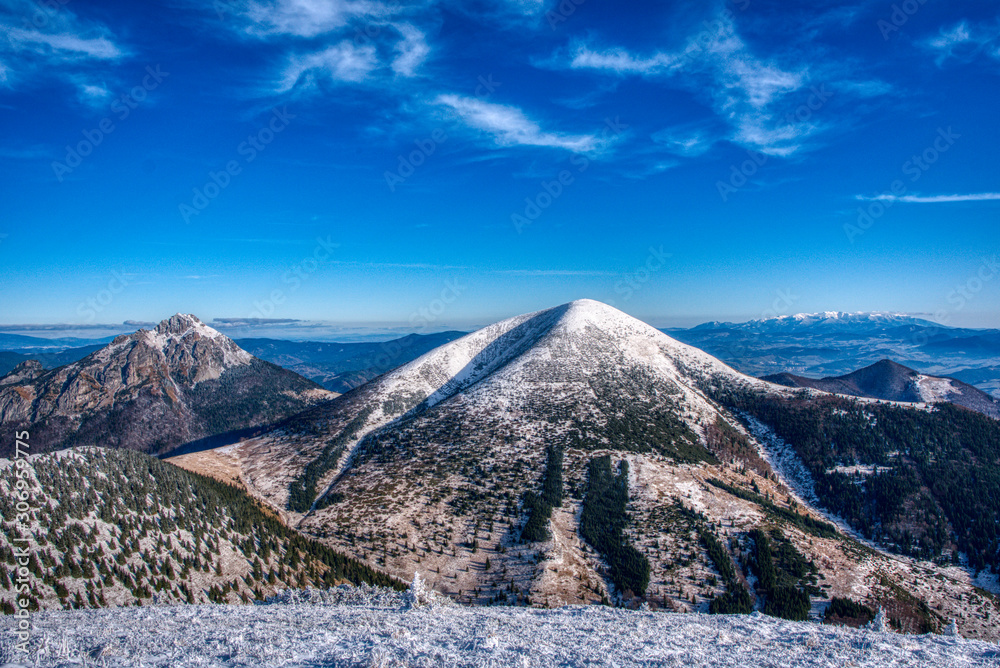 Mountain under snow cover with High Tatras in the background