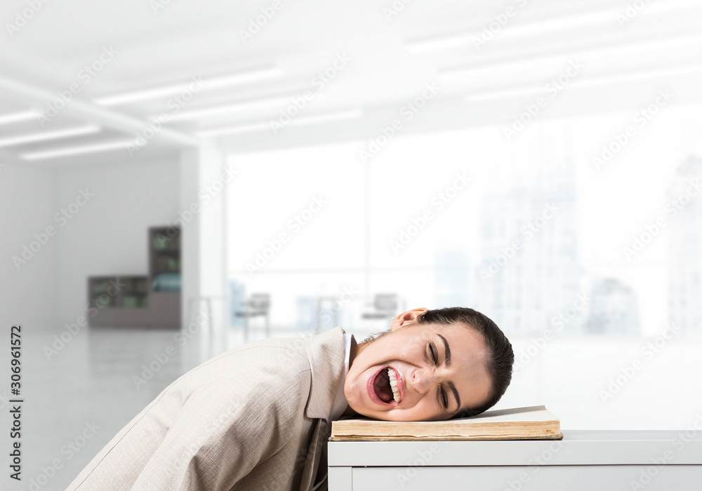 Bored business woman lying on desk Bored business woman lying on desk