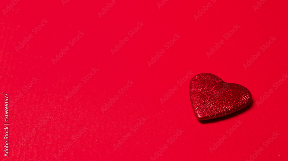 Red heart isolated on a red background with copy space. Love, wedding and Valentine's Day concept. Red heart isolated on a red background with copy space. Love, wedding and Valentine's Day concept.