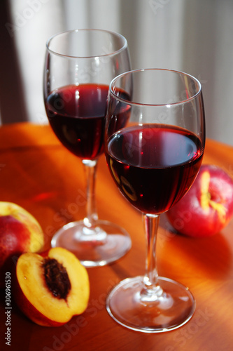 Two glasses with red wine with peaches	