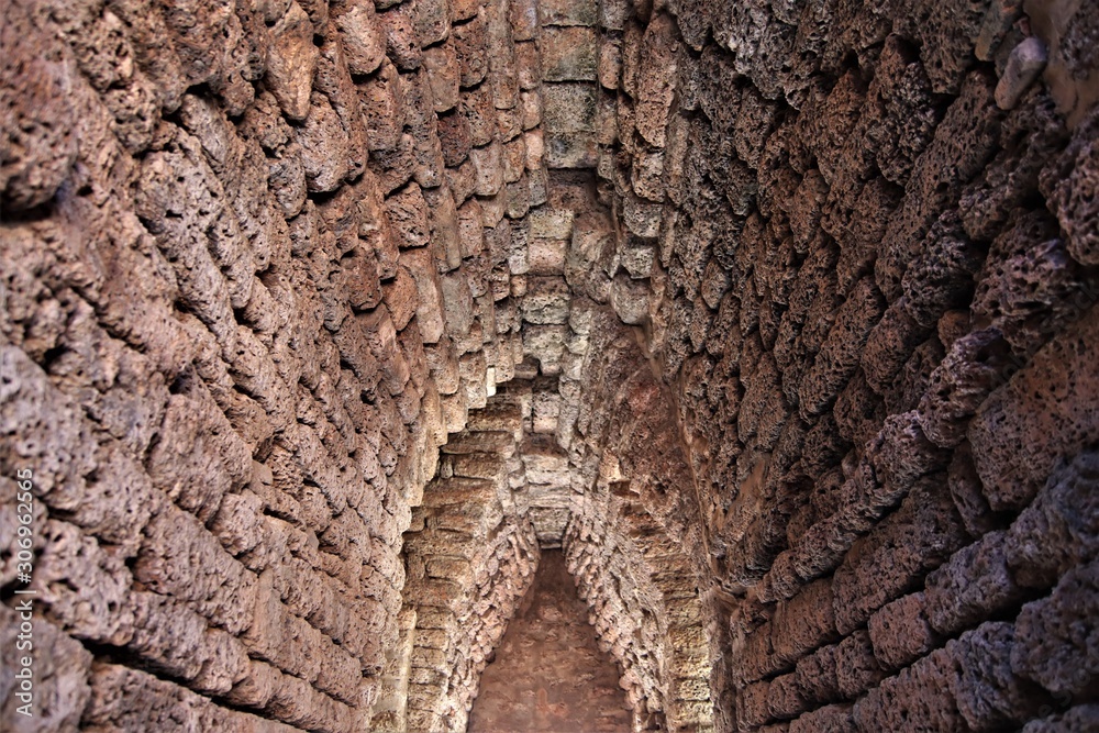 Abstract blurred old stone brick tunnel entrance pattern texture background perspective light and shadow with selective focus Abstract blurred old stone brick tunnel entrance pattern texture background perspective light and shadow with selective focus
