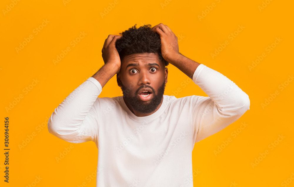 Shocked black guy with open mouth touching his head Stock Photo Adobe