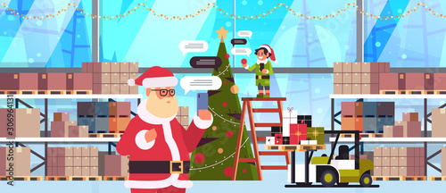 santa with male elf helper chatting using mobile app on smartphone social network chat bubble communication concept modern warehouse interior portrait horizontal vector illustration