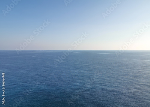 Empty calm blue sea and skyline against a clear sky. Minimalism concept