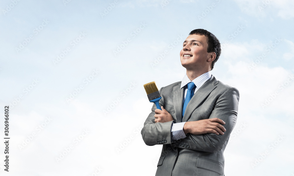 Creative businessman painter holding paintbrush Creative businessman painter holding paintbrush