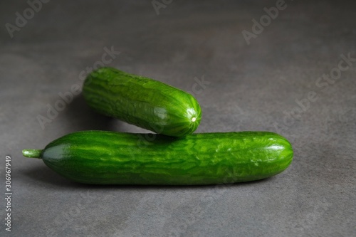 Fresh green cucumbers on a dark background 