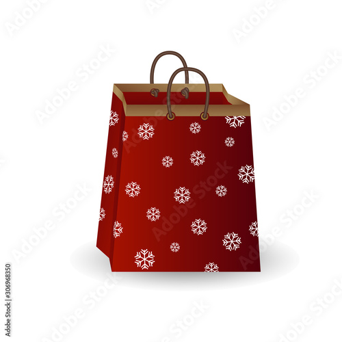 Party festive gift bag of red paper with golden ribbon decorated with a winter pattern of snowflakes isolated on a white background