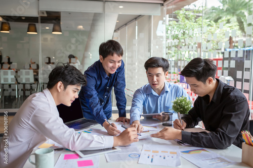 Group of young asian businessman together share opinions and propose new marketing and business ideas at meeting.