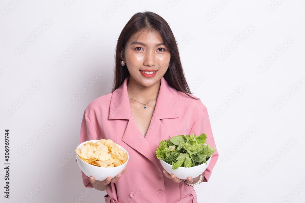 Young Asian woman with potato chips and salad. Young Asian woman with potato chips and salad.