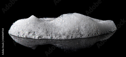 Soap foam Shaving cream bubble isolated on black background photo
