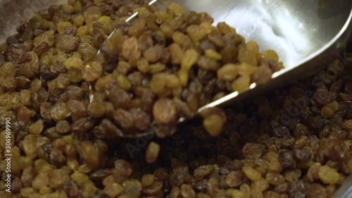 Picking raisins on a farmers market. Slow motion video.
