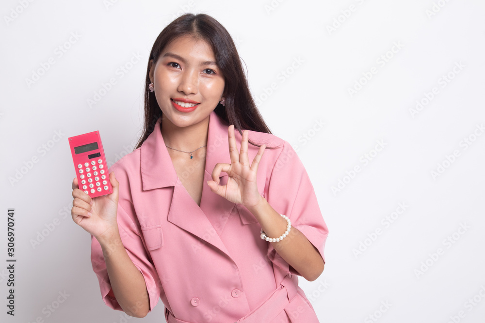 Asian woman show OK with calculator. Asian woman show OK with calculator.