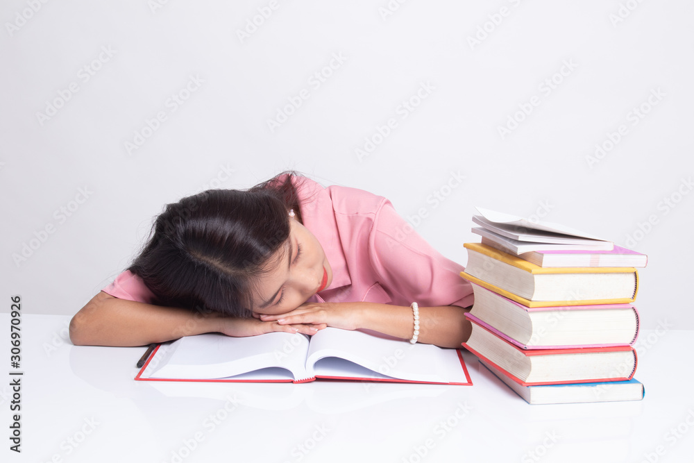 Exhausted Young Asian woman sleep with books on table. Exhausted Young Asian woman sleep with books on table.