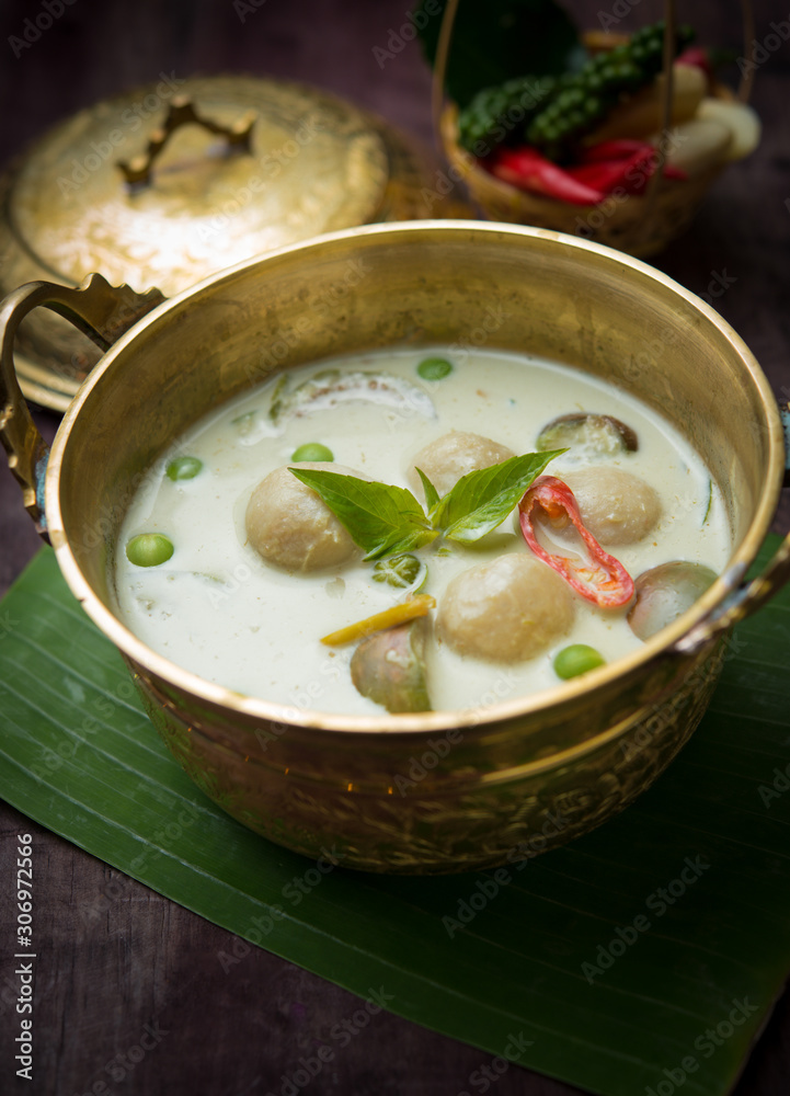 Fish ball green curry, creamy soup, with eggplant on wood table,Thai food Fish ball green curry, creamy soup, with eggplant on wood table,Thai food