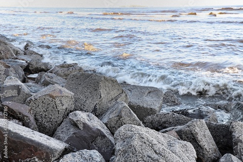 Fototapeta Naklejka Na Ścianę i Meble -  Rock barrier arranged to hold back approaching tide