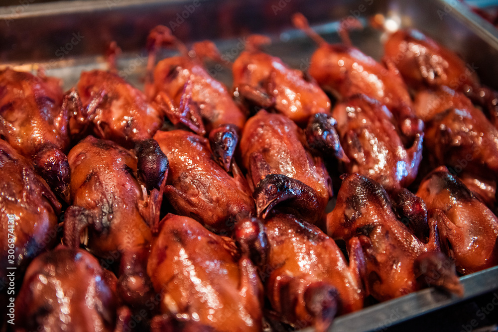 Fried pigeons in a food market in Beijing, China. Fried pigeons in a food market in Beijing, China.