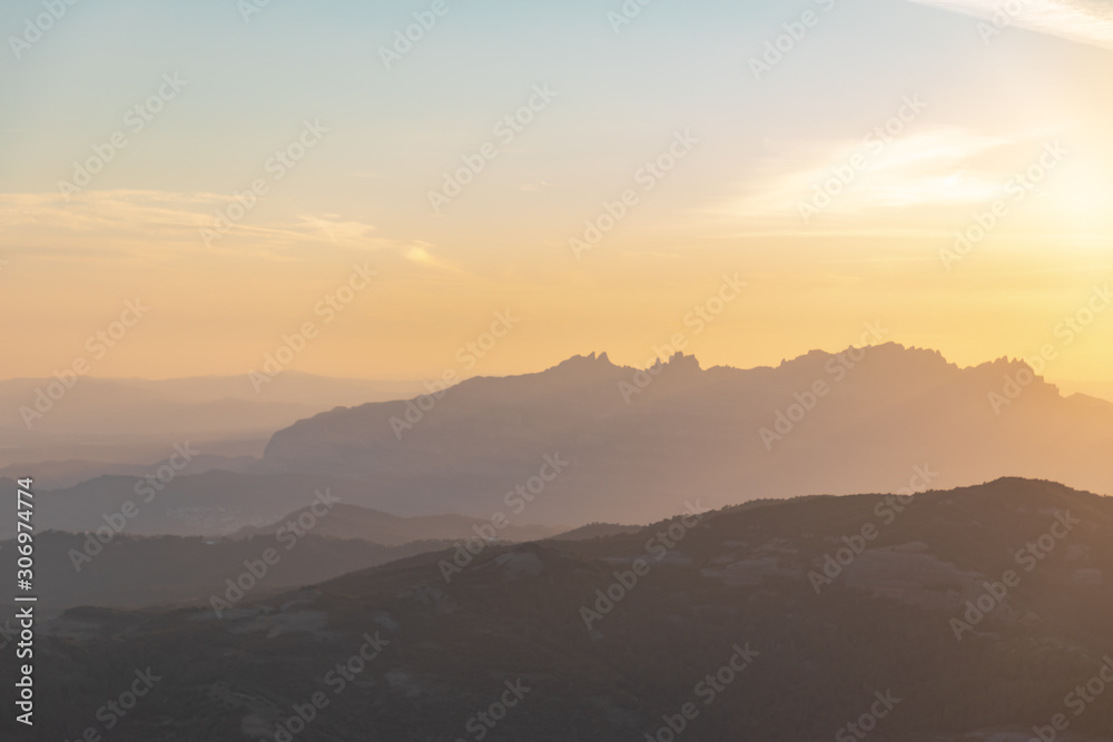 Views at sunset of Montserrat silhouette with blue and orange sky in Catalonia, Spain